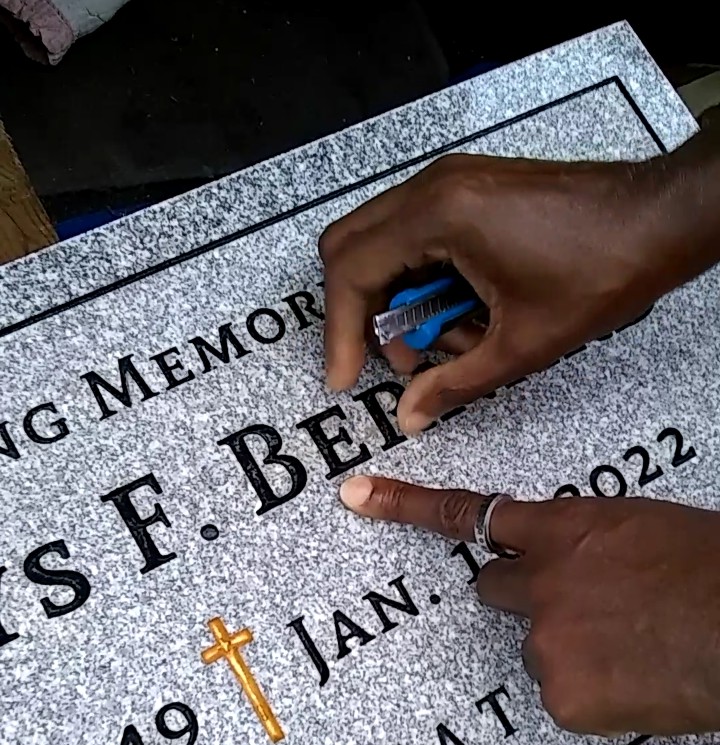 hand touching granite in Spring Grove Cemetery